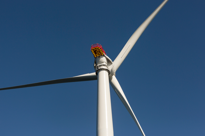 The top of this Haliade turbine includes a nacelle, where the generator and rotor are housed, a helipad (yellow structure) and three enormous fiberglass blades. Photo: Jesse Burke for Gizmodo